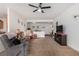 Bright and airy living room with neutral walls, plush carpeting, and a ceiling fan at 7927 Crested Starling Ct, North Las Vegas, NV 89084