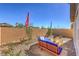 Serene backyard showcasing modern seating, landscaping, and a clear blue sky at 799 Calm Crystal Ct # Lot 142, North Las Vegas, NV 89081
