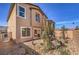 Exterior view of a home featuring a backyard with patio and desert landscaping at 799 Calm Crystal Ct # Lot 142, North Las Vegas, NV 89081