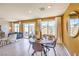 Bright dining area featuring a wooden table set for four, with natural light streaming through large windows at 799 Calm Crystal Ct # Lot 142, North Las Vegas, NV 89081
