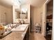 Bathroom with granite countertop, double vanity, framed mirrors, and beige walls at 8101 W Flamingo Rd # 2006, Las Vegas, NV 89147