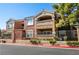 Multi-colored condo building with wrought iron fencing and mature shade tree at 8101 W Flamingo Rd # 2006, Las Vegas, NV 89147