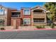 Multi-colored condo building with wrought iron fencing and lush green landscaping at 8101 W Flamingo Rd # 2006, Las Vegas, NV 89147