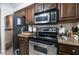 The kitchen is equipped with stainless steel appliances and dark wood cabinetry at 8101 W Flamingo Rd # 2006, Las Vegas, NV 89147