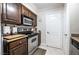 A kitchen features stainless steel appliances, dark wood cabinetry, and tile flooring at 8101 W Flamingo Rd # 2006, Las Vegas, NV 89147