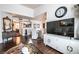 Elegant living room with dark wood floors, dining area, television, and a decorative mirror over an antique dresser at 8101 W Flamingo Rd # 2006, Las Vegas, NV 89147