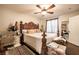 A large main bedroom features a king-sized bed with decorative headboard and ceiling fan at 8101 W Flamingo Rd # 2006, Las Vegas, NV 89147