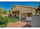 This home features a covered patio, a lovely green lawn, and mature trees offering a private backyard space at 8129 Jim Steele Falls St, North Las Vegas, NV 89085