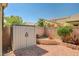 Enclosed backyard features rock landscaping, brick wall, and convenient outdoor storage unit for tools and equipment at 8129 Jim Steele Falls St, North Las Vegas, NV 89085