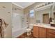 Well-lit bathroom featuring tile flooring, a tub-shower combo, modern vanity, and neutral color scheme at 8129 Jim Steele Falls St, North Las Vegas, NV 89085