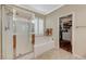 Bathroom featuring a glass shower, a soaking tub, and door to walk-in closet at 8129 Jim Steele Falls St, North Las Vegas, NV 89085