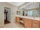Bathroom featuring double sinks, a vanity area, and a door to the walk-in closet at 8129 Jim Steele Falls St, North Las Vegas, NV 89085