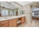 Bathroom featuring double sinks, a vanity area, and a doorway leading to bedroom at 8129 Jim Steele Falls St, North Las Vegas, NV 89085
