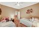 Bright bedroom featuring two twin beds, neutral colors, and natural light from a window with shutters at 8129 Jim Steele Falls St, North Las Vegas, NV 89085