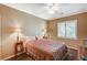 Comfortable bedroom with large bed, side tables and natural light from a window with shutters at 8129 Jim Steele Falls St, North Las Vegas, NV 89085
