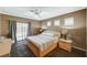 Comfortable bedroom featuring a ceiling fan, carpet, and sliding glass doors to the backyard at 8129 Jim Steele Falls St, North Las Vegas, NV 89085