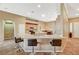 Open kitchen with a large island, breakfast bar seating, and stainless steel appliances at 8129 Jim Steele Falls St, North Las Vegas, NV 89085