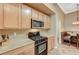 Close-up of a modern kitchen with stainless steel appliances and wood cabinets at 8129 Jim Steele Falls St, North Las Vegas, NV 89085