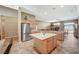 Bright kitchen with stainless appliances, island, and view into the living room with fireplace at 8129 Jim Steele Falls St, North Las Vegas, NV 89085