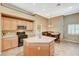 Functional kitchen featuring an island with countertop seating and modern appliances at 8129 Jim Steele Falls St, North Las Vegas, NV 89085