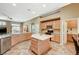 Well-equipped kitchen with an island, stainless steel dishwasher, and seamless flow to the dining area at 8129 Jim Steele Falls St, North Las Vegas, NV 89085