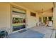 Cozy covered patio with outdoor seating, a well-maintained lawn, and convenient access to the house at 8129 Jim Steele Falls St, North Las Vegas, NV 89085