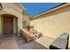 Cozy front patio area with comfortable seating, brick flooring, and a warm, welcoming atmosphere at 8129 Jim Steele Falls St, North Las Vegas, NV 89085