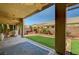 Inviting covered patio with a well-maintained lawn and landscaping, perfect for outdoor entertaining at 8129 Jim Steele Falls St, North Las Vegas, NV 89085