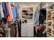 Walk-in closet featuring built-in shelving, drawers, and rods for ample storage at 8129 Jim Steele Falls St, North Las Vegas, NV 89085