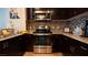 Close-up of kitchen featuring stainless steel oven, microwave, and granite countertops at 8255 S Las Vegas Blvd # 1514, Las Vegas, NV 89123