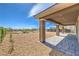 Covered back porch with stone flooring offers views of desert landscaping and neighborhood at 8316 Broad Peak Dr, Las Vegas, NV 89131