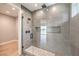 Modern walk-in shower with dual shower heads, a built-in bench, and a glass door at 8316 Broad Peak Dr, Las Vegas, NV 89131