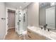 Bathroom featuring tiled shower, marble countertops, and modern black hardware at 8316 Broad Peak Dr, Las Vegas, NV 89131