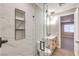 Modern bathroom featuring marble-look shower, marble counters and modern fixtures at 8316 Broad Peak Dr, Las Vegas, NV 89131