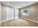 Neutral bedroom featuring hardwood floors, closet, and large window at 8316 Broad Peak Dr, Las Vegas, NV 89131