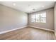 Bright, empty bedroom with hardwood floors and large window at 8316 Broad Peak Dr, Las Vegas, NV 89131