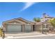 Charming single-story home featuring a two-car garage, desert landscaping, and a well-maintained yard at 8316 Broad Peak Dr, Las Vegas, NV 89131