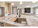 Close-up of a kitchen with a large island, a modern faucet, and an open floor plan at 8316 Broad Peak Dr, Las Vegas, NV 89131