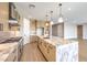 Modern kitchen features a large island with marble countertop and stainless steel appliances at 8316 Broad Peak Dr, Las Vegas, NV 89131