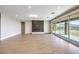 Spacious living room with wood floors, a modern fireplace feature, and a sliding glass door with backyard views at 8316 Broad Peak Dr, Las Vegas, NV 89131
