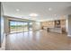 Open-concept floor plan with wood floors, a modern fireplace, sliding glass doors, and an eat-in kitchen at 8316 Broad Peak Dr, Las Vegas, NV 89131