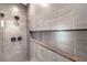 Modern shower featuring neutral tiling, built-in shelf, and sleek matte black hardware at 8316 Broad Peak Dr, Las Vegas, NV 89131