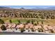 Aerial view of neighborhood with desert landscaping, tree-lined streets, golf course, and mountain views at 9520 Sundial Dr, Las Vegas, NV 89134