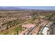 Aerial view of neighborhood with desert landscaping, tree-lined streets, golf course, and mountain views at 9520 Sundial Dr, Las Vegas, NV 89134