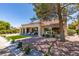 Charming backyard with covered patio, desert landscaping, and tile roof at 9520 Sundial Dr, Las Vegas, NV 89134