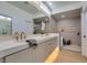 Bright bathroom featuring quartz countertops, dual sinks, and step in shower at 9520 Sundial Dr, Las Vegas, NV 89134