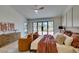Bright bedroom featuring neutral paint, wood floors, and large picture window at 9520 Sundial Dr, Las Vegas, NV 89134