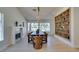 Dining area showcases a modern table, fireplace, built-in bookcase, and picturesque views from large windows at 9520 Sundial Dr, Las Vegas, NV 89134