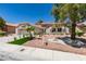Single story home with desert landscaping, tile roof, artificial turf, and three car garage at 9520 Sundial Dr, Las Vegas, NV 89134