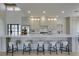 Modern kitchen with stainless steel appliances, ample counter space, and five barstool chairs at 9520 Sundial Dr, Las Vegas, NV 89134